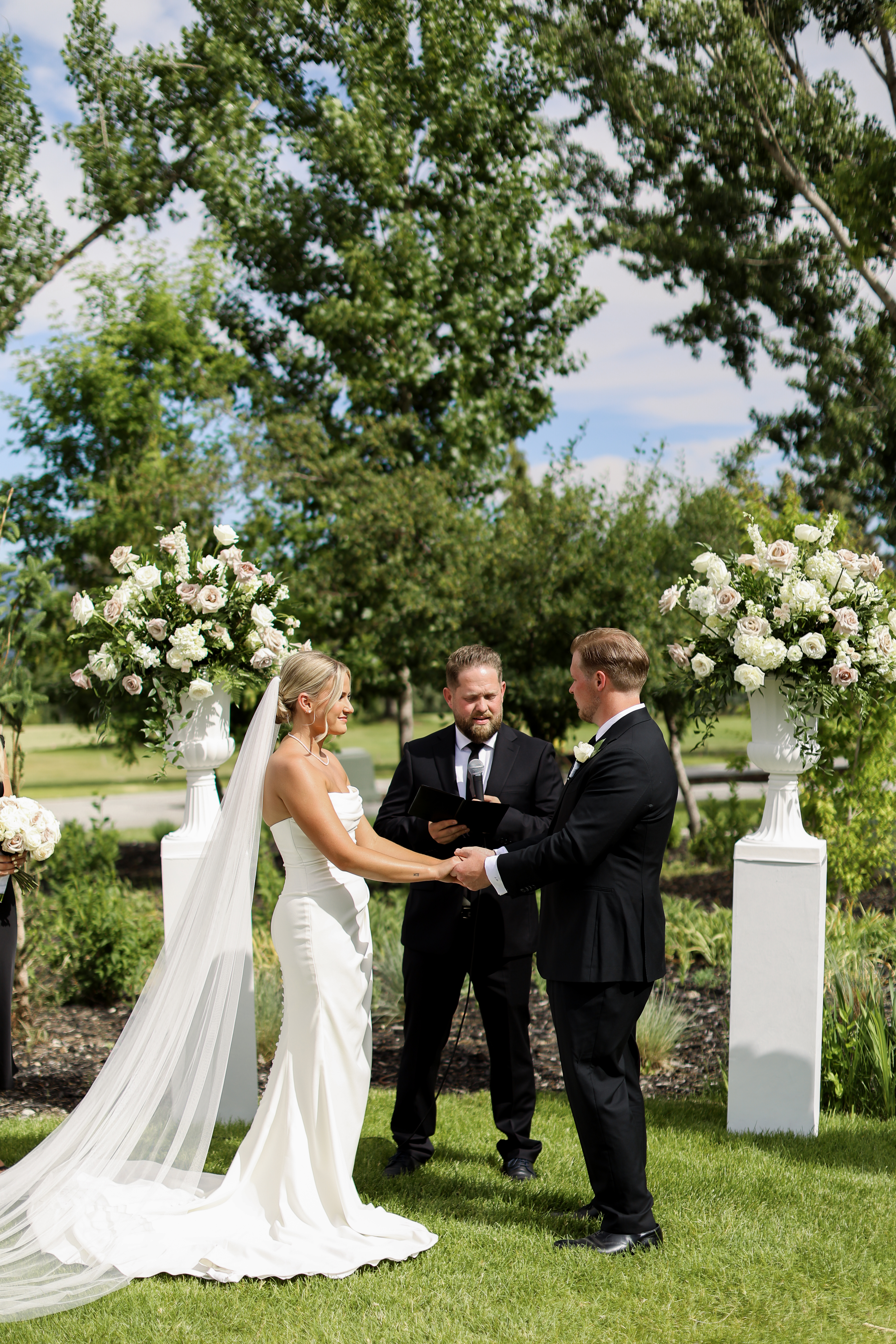 Outdoor wedding ceremony with wooden arch and elegant seating