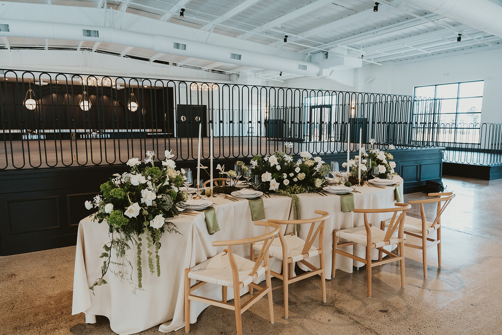 Stunning outdoor reception with string lights and waterfront view