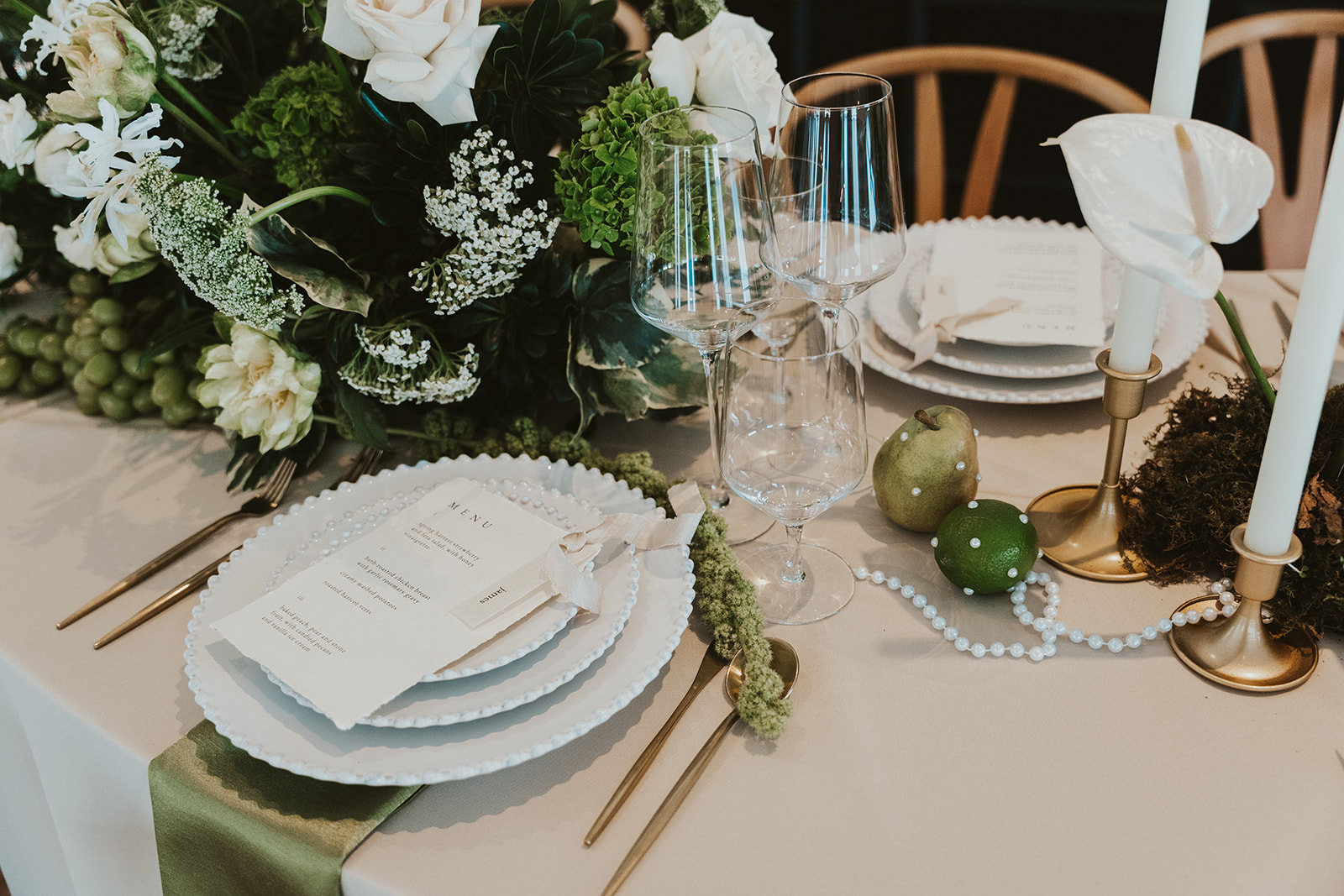 Elegant wedding table setting with fine china, crystal glassware, and romantic candlelight