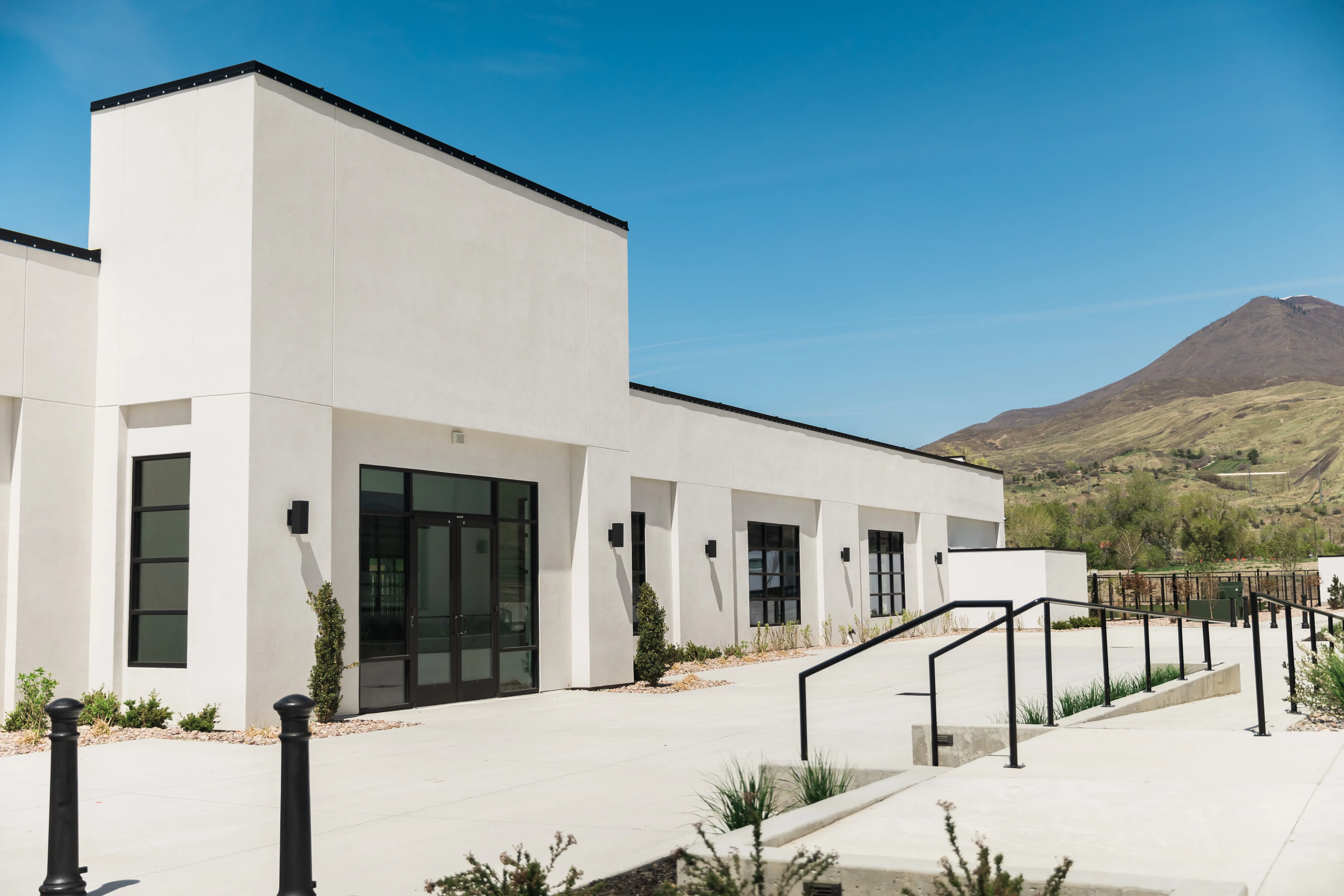 The Belvedere Provo - Modern white stucco venue with stunning mountain backdrop
