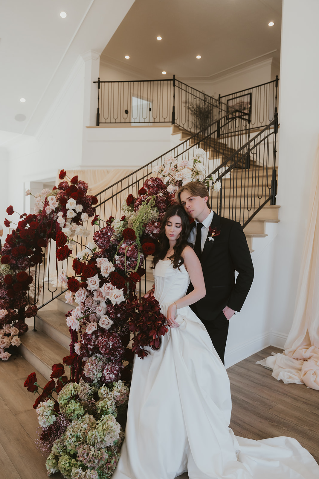 Elegant wedding cake table setup with floral arrangements